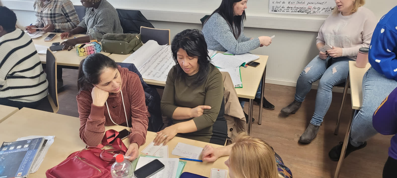 Students practising German in pairs during a lesson